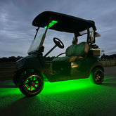 Golf cart with green underglow lighting on a dark night